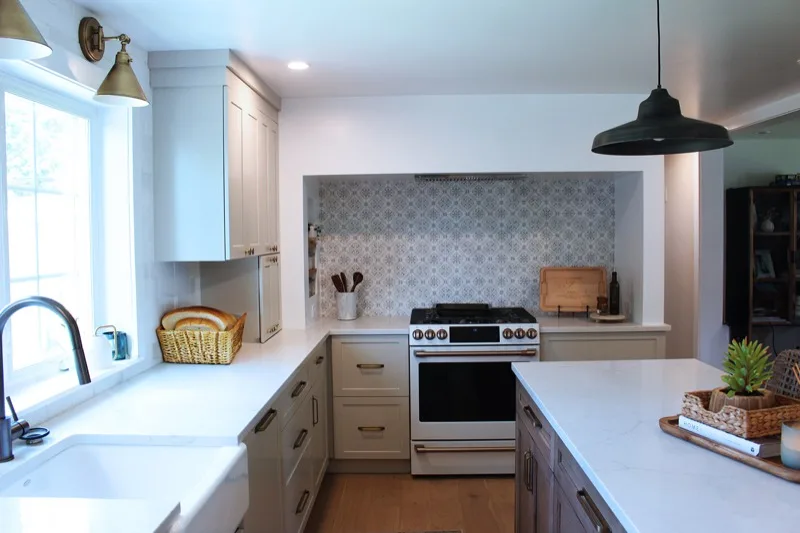 Kitchen renovation with custom cabinetry and patterned tile backsplash